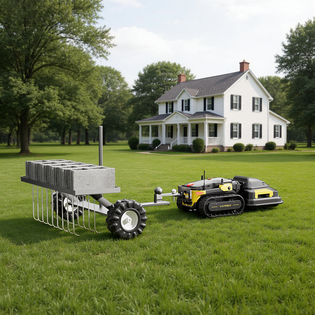 Metal back brace mount for Y Series robot lawn mower, attached to trailer with cinder blocks, on grassy lawn, side view