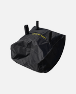 Black protective cover with yellow logo and three top handles, by YARD, shown in angled view with visible stitching and durable fabric texture.